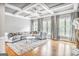 Bright living room with hardwood floors, coffered ceiling, fireplace, and neutral decor at 4818 Moon Hollow Ct, Buford, GA 30519