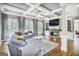 Spacious living room with coffered ceilings, hardwood floors, and a stone fireplace at 4818 Moon Hollow Ct, Buford, GA 30519