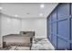 Modern office space with built-in desk, stylish blue accent wall, and ample lighting, perfect for a productive work environment at 4818 Moon Hollow Ct, Buford, GA 30519