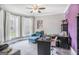Office space with many large windows, a blue sofa, desk, and ample natural light at 4818 Moon Hollow Ct, Buford, GA 30519