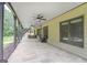 Expansive covered patio featuring tile flooring, ceiling fans, and outdoor seating, offering a perfect space for entertaining at 4818 Moon Hollow Ct, Buford, GA 30519