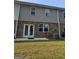 Backyard view featuring a patio, lawn, and the rear facade of the house with brick and siding at 190 Hampton Cir, Mcdonough, GA 30253