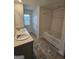 Bathroom featuring double sinks, a soaking tub, tiled flooring, and natural light at 190 Hampton Cir, Mcdonough, GA 30253