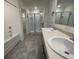 Bathroom featuring double sink vanity, separate tub, and glass-enclosed shower at 190 Hampton Cir, Mcdonough, GA 30253