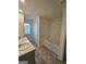 Bathroom featuring double sinks, a soaking tub with shower, tiled flooring, and natural light at 190 Hampton Cir, Mcdonough, GA 30253