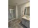 Bathroom featuring tiled floors, a glass-enclosed shower, and a neutral-colored vanity at 190 Hampton Cir, Mcdonough, GA 30253