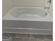 Close up of a modern bathtub in a bright bathroom with tile floor at 190 Hampton Cir, Mcdonough, GA 30253