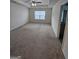 Spacious bedroom featuring plush carpeting, a ceiling fan, and a window for natural light at 190 Hampton Cir, Mcdonough, GA 30253