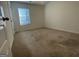 Bedroom with neutral carpet, window, and white door at 190 Hampton Cir, Mcdonough, GA 30253