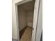A small, carpeted closet with shelving and a neutral color scheme at 190 Hampton Cir, Mcdonough, GA 30253