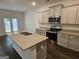 Well-equipped kitchen featuring granite countertops, stainless steel appliances, and a center island with a sink at 190 Hampton Cir, Mcdonough, GA 30253