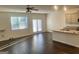 Open living space featuring hardwood floors, a ceiling fan, and an adjacent open concept kitchen at 190 Hampton Cir, Mcdonough, GA 30253