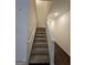 Carpeted staircase leading up to the next level of the home at 190 Hampton Cir, Mcdonough, GA 30253