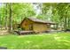 Back view of the log cabin home with private back deck and wooded yard at 349 Campground Rd, Mcdonough, GA 30253