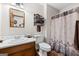 Cozy bathroom features a wood vanity, white sink, and decorative shower curtain at 349 Campground Rd, Mcdonough, GA 30253