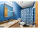 Blue bathroom with patterned shower curtain and a vanity with a faux stone countertop at 349 Campground Rd, Mcdonough, GA 30253