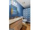 Bathroom featuring blue walls, patterned shower curtain, and vanity with faux stone countertop at 349 Campground Rd, Mcdonough, GA 30253