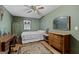 Bedroom featuring green walls, hardwood floors, double bed, ceiling fan, and natural light at 349 Campground Rd, Mcdonough, GA 30253