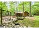 Beautifully landscaped log cabin with a charming front porch and mature trees at 349 Campground Rd, Mcdonough, GA 30253