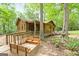 Charming log cabin featuring a welcoming ramp and a cozy front porch area at 349 Campground Rd, Mcdonough, GA 30253