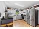Modern kitchen with stainless steel appliances, white cabinets, and hardwood floors at 349 Campground Rd, Mcdonough, GA 30253