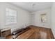 Well-lit bedroom with original hardwood floors, two windows, and a closet at 397 Campground Rd, Mcdonough, GA 30253