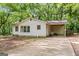 View of the exterior of the home showing the carport and surrounding landscaping at 397 Campground Rd, Mcdonough, GA 30253