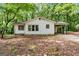 Charming single-story home with a covered parking area surrounded by mature trees at 397 Campground Rd, Mcdonough, GA 30253