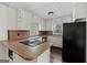Bright kitchen features classic cabinetry, wood countertops, and an electric cooktop at 397 Campground Rd, Mcdonough, GA 30253