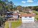 Aerial view of a multi-building property, featuring manicured lawn and mature trees at 387 Colvin Dr, Locust Grove, GA 30248