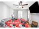 This cozy bedroom is brightened by natural light, complemented by hardwood floors and a ceiling fan at 387 Colvin Dr, Locust Grove, GA 30248