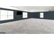 Large bonus room with neutral carpet, dark walls, and natural light at 387 Colvin Dr, Locust Grove, GA 30248