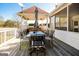 Outdoor deck featuring a dining table with umbrella and seating at 387 Colvin Dr, Locust Grove, GA 30248