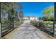 Wide driveway leading to a charming home, framed by wooden fences and lush greenery at 387 Colvin Dr, Locust Grove, GA 30248