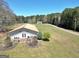 Picturesque property with a well-manicured lawn and outbuilding offering outdoor space at 387 Colvin Dr, Locust Grove, GA 30248