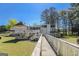 Unique exterior features a charming walkway to a multi-level deck with views of the surrounding greenery and backyard at 387 Colvin Dr, Locust Grove, GA 30248