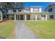 Charming home with a covered front porch, pillars, and meticulously maintained landscaping at 387 Colvin Dr, Locust Grove, GA 30248