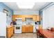 Cozy kitchen with oak cabinets, white appliances, and tile flooring at 387 Colvin Dr, Locust Grove, GA 30248