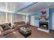 Cozy living room with a fireplace, plush couches, and ample natural light at 387 Colvin Dr, Locust Grove, GA 30248