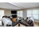 Cozy living room with hardwood floors, fireplace, and abundant natural light from windows at 387 Colvin Dr, Locust Grove, GA 30248