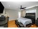 Spacious main bedroom features hardwood floors, a ceiling fan, and a cozy atmosphere for relaxation at 387 Colvin Dr, Locust Grove, GA 30248