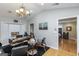 Home office featuring hardwood floors, a chandelier, and a view to the bedroom at 387 Colvin Dr, Locust Grove, GA 30248