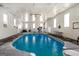 Enclosed in-ground pool with many windows, slide, and lounge seating at 387 Colvin Dr, Locust Grove, GA 30248
