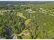 Aerial view of a home with a large yard, nestled among green trees in a quiet area at 75 Auburn Rd, Auburn, GA 30011
