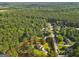 An aerial view showcasing property lines around a home on a wooded lot in a residential neighborhood at 75 Auburn Rd, Auburn, GA 30011