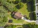 Birds eye view of a home with a long driveway and mature landscaping around the home at 75 Auburn Rd, Auburn, GA 30011