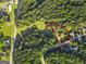 Aerial view of a home surrounded by lush greenery, outlined in red to highlight property lines at 75 Auburn Rd, Auburn, GA 30011