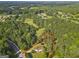 Aerial view displaying property lines of a house nestled among many trees in a rural neighborhood at 75 Auburn Rd, Auburn, GA 30011