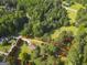 An aerial view displays the property lines of this residence with a well-kept lawn and treed perimeter at 75 Auburn Rd, Auburn, GA 30011