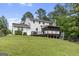 Back of house with spacious yard, deck, and screened in porch at 75 Auburn Rd, Auburn, GA 30011